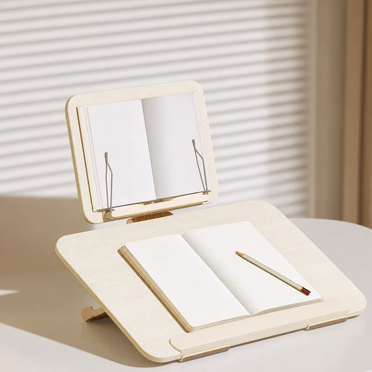Support de lecture pliable sur un bureau avec livre sur le porte-livre et cahier sur le plateau d'écriture